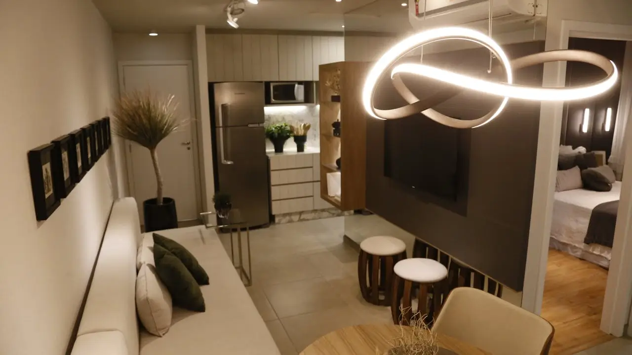 A beautifully illuminated modern living room demonstrating seamless layered lighting minimalist home design.